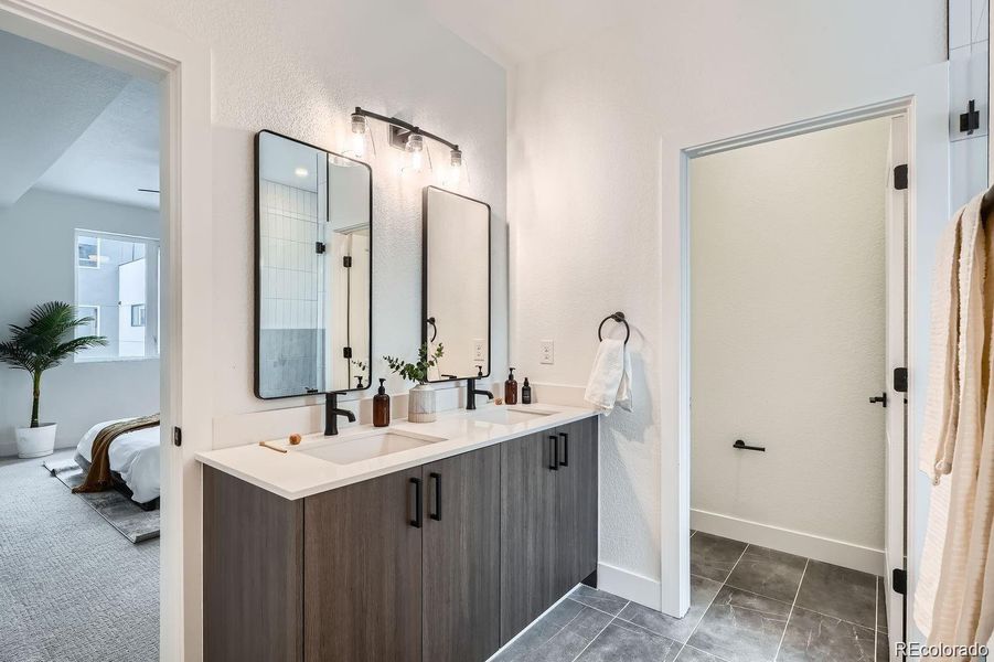 Primary ensuite with double vanity, designer finishes, and quartz countertops.