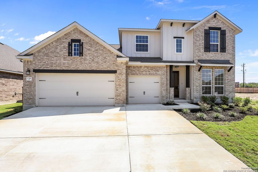 Front exterior of a new home in Megan's Landing, Castroville, TX, highlighting curb appeal (Image 17).