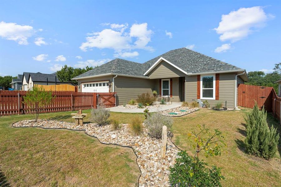 Single story home featuring an attached garage and a patio area