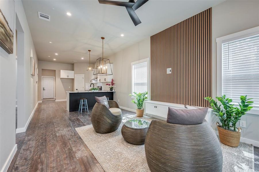 Living area with recessed lighting, dark wood-style flooring, a ceiling fan, and a chandelier