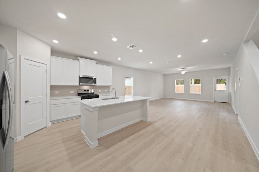 A large kitchen with white cabinets. A large kitchen with white cabinets.
