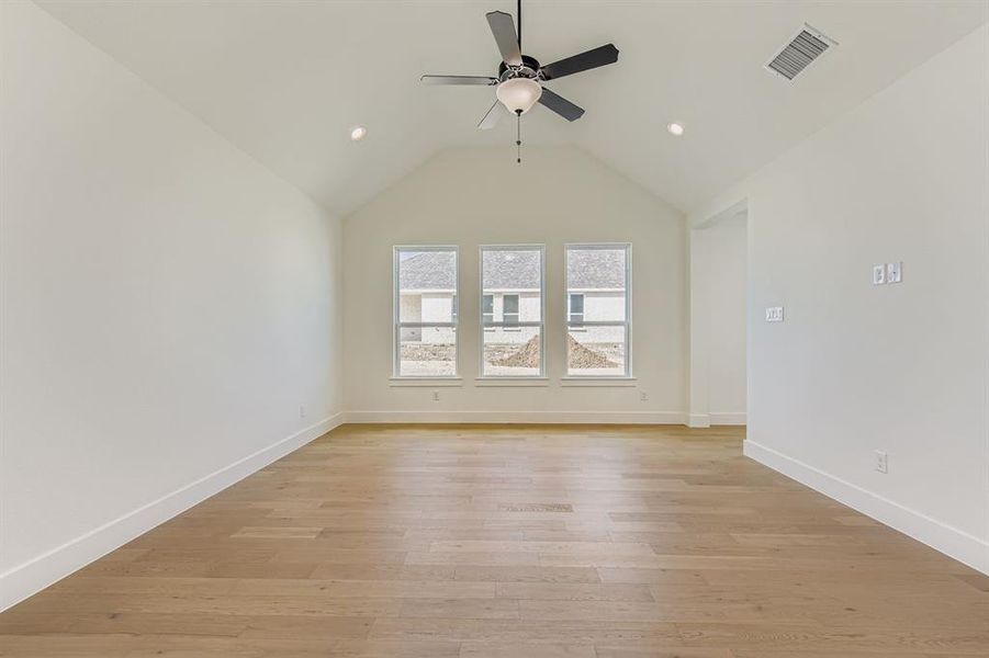 Spare room with light wood-style floors, lofted ceiling, recessed lighting, and ceiling fan Spare room with light wood-style floors, lofted ceiling, recessed lighting, and ceiling fan