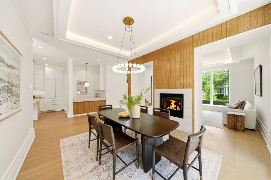 Open flow dining room showcasing intricate oak detailing and striking fireplace. Open flow dining room showcasing intricate oak detailing and striking fireplace.