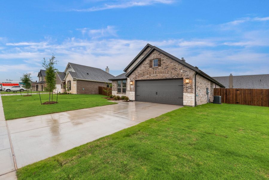 Front exterior of a new home in Aero Vista, Caddo Mills, TX, highlighting curb appeal (Image 24).