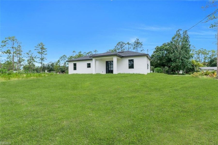 Front exterior of a new home in , Lehigh Acres, FL, highlighting curb appeal (Image 18).
