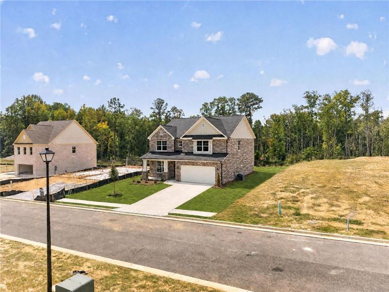 Front exterior of a new home in , Loganville, GA, highlighting curb appeal (Image 32).
