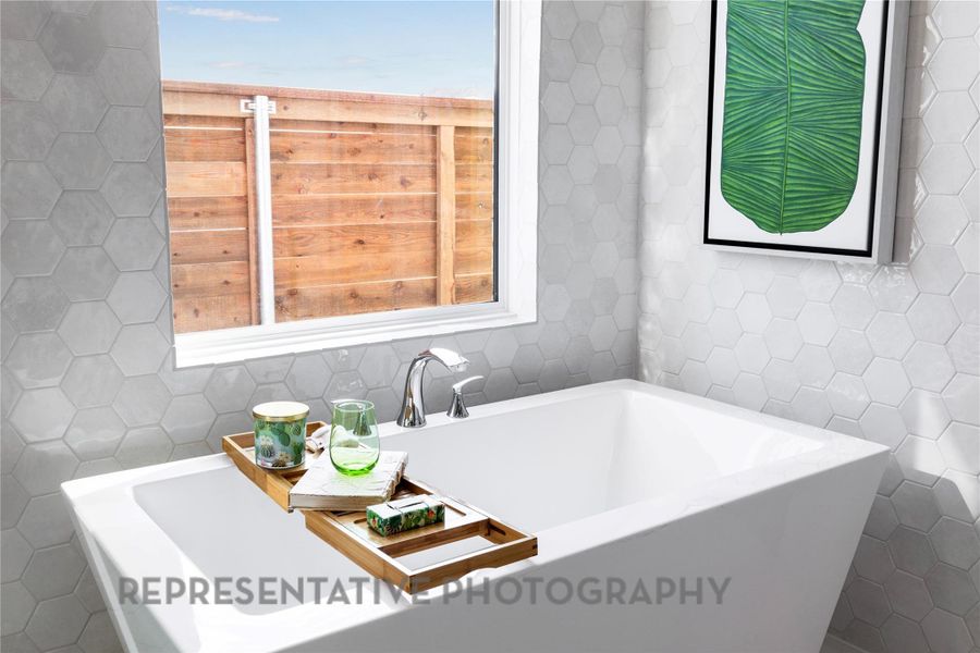 Full bath with tile walls, a garden tub, and tile patterned flooring