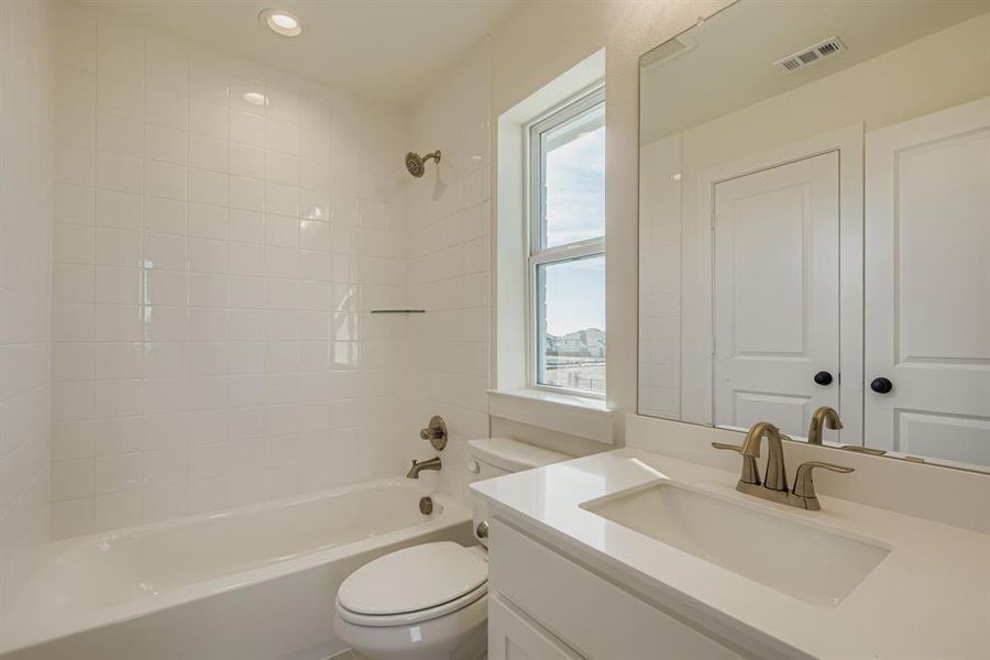 Full bathroom with vanity, shower / bath combination, and recessed lighting