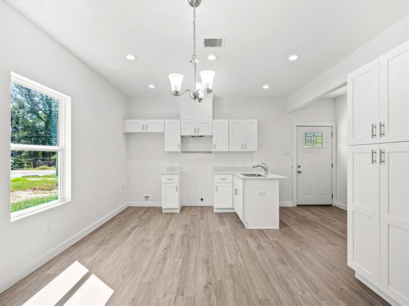 Modern design with quartz countertops, a pantry, and ample natural light.