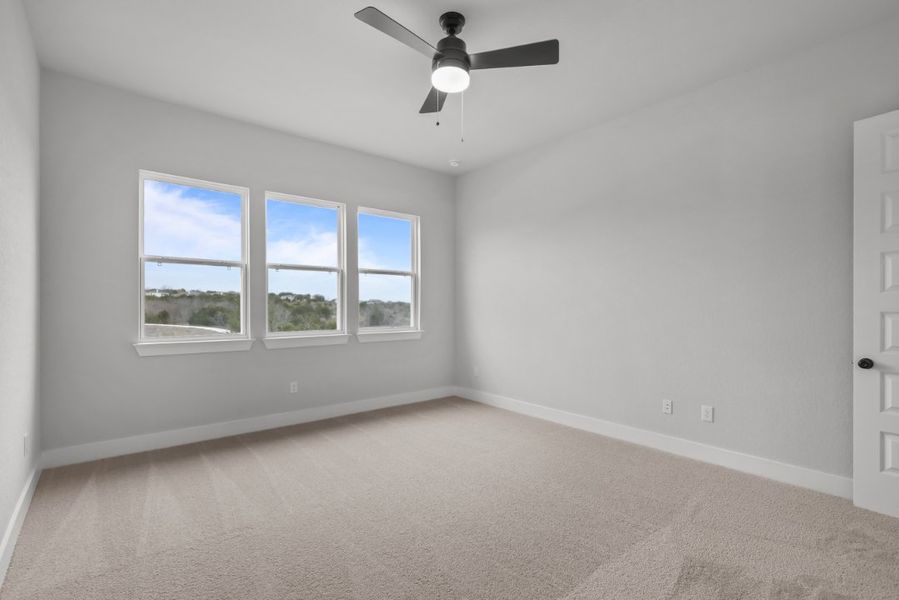 A room with a ceiling fan and windows. A room with a ceiling fan and windows.