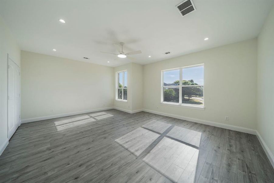 Spare room featuring recessed lighting, wood finished floors, and a ceiling fan Spare room featuring recessed lighting, wood finished floors, and a ceiling fan