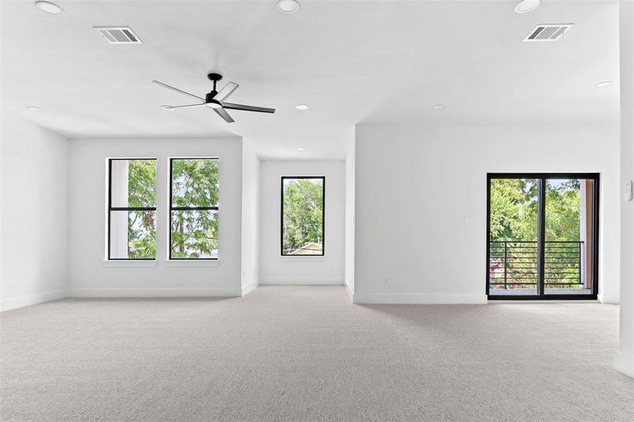 Spare room with ceiling fan, light carpet, and a healthy amount of sunlight