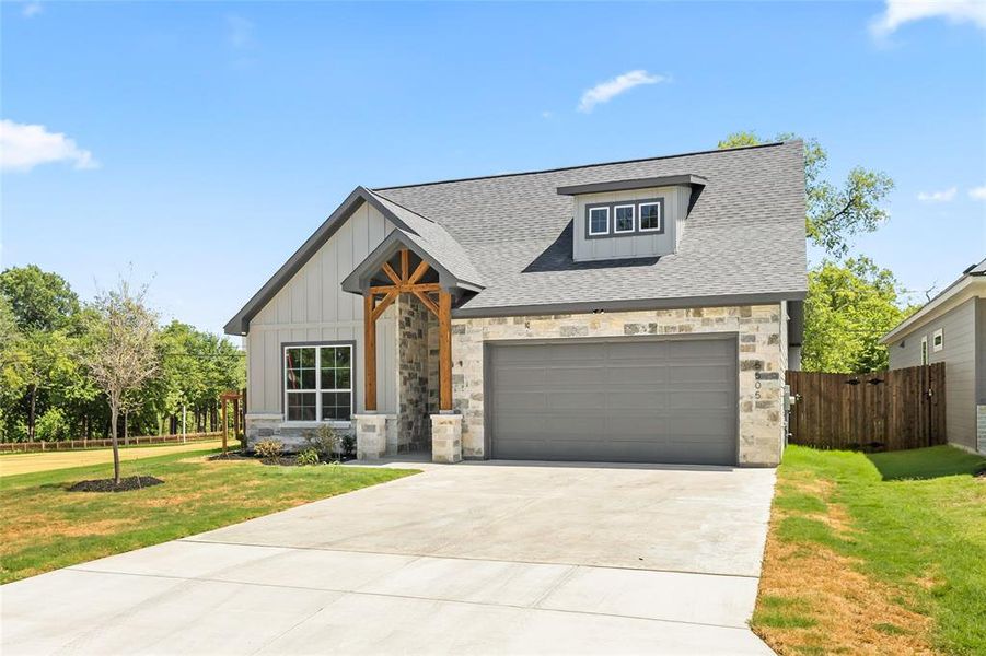 Contemporary home featuring stone and vertical siding exterior