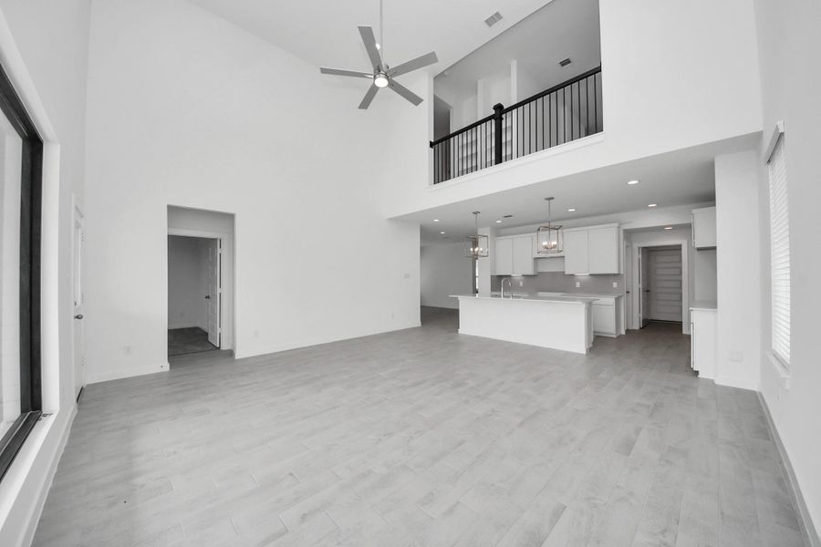 Family room flooded with natural light through the expansive windows. The premium tile flooring adds a touch of luxury to the space, creating the perfect setting for relaxing moments and cherished gatherings with loved ones. Sample photo of completed home with similar floor plan. Actual colors and selections may vary. Family room flooded with natural light through the expansive windows. The premium tile flooring adds a touch of luxury to the space, creating the perfect setting for relaxing moments and cherished gatherings with loved ones. Sample photo of completed home with similar floor plan. Actual colors and selections may vary.