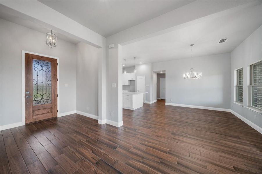 Entryway featuring dark hardwood / wood-style flooring and an inviting chandelier