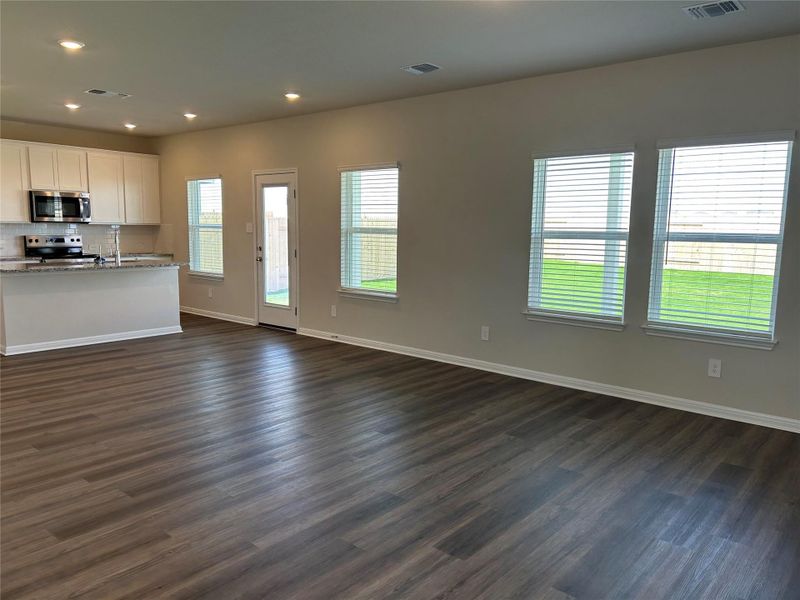 Unfurnished living room featuring recessed lighting and dark wood finished floors Unfurnished living room featuring recessed lighting and dark wood finished floors