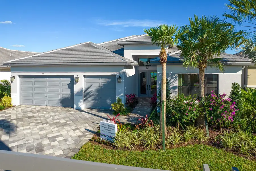 Front exterior of a new home in Valencia Parc at Riverland, Port St. Lucie, FL, highlighting curb appeal (Image 1). Front exterior of a new home in Valencia Parc at Riverland, Port St. Lucie, FL, highlighting curb appeal (Image 1).
