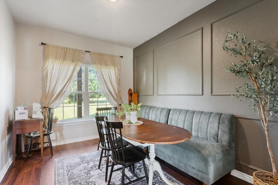 Dining room featuring dark wood finished floors and baseboards