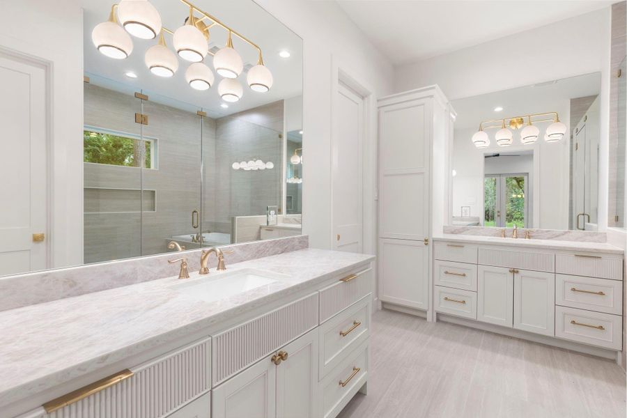 Separate vanities with plenty of space, lighting, and storage. Separate vanities with plenty of space, lighting, and storage.