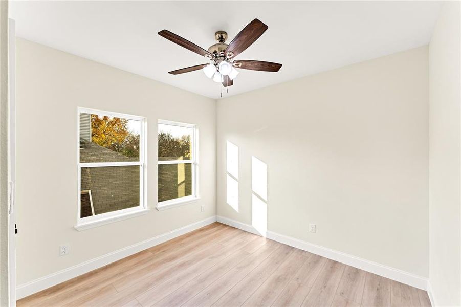 Unfurnished room featuring light wood-type flooring and ceiling fan