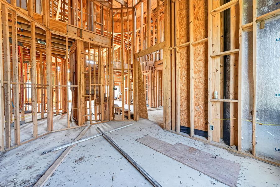 Open unfinished space showcasing framing and build progress.