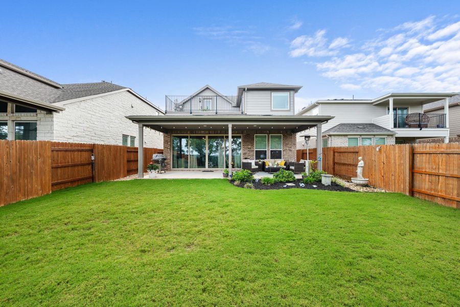 An inviting covered patio and lush lawn define the ample, fenced backyard. An inviting covered patio and lush lawn define the ample, fenced backyard.