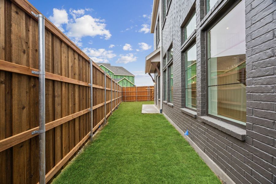 Exterior details and patio area of a home in Newman Village Townhomes, Frisco (Image 15).