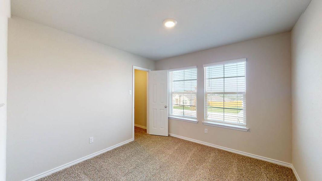 Unfurnished bedroom featuring carpet floors and baseboards