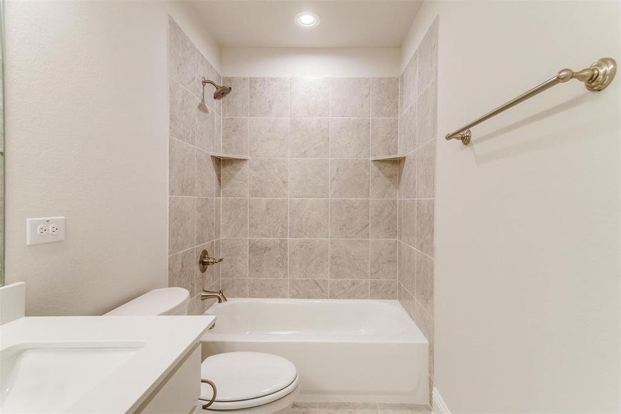Bathroom with shower / bath combination, vanity, and tile patterned flooring