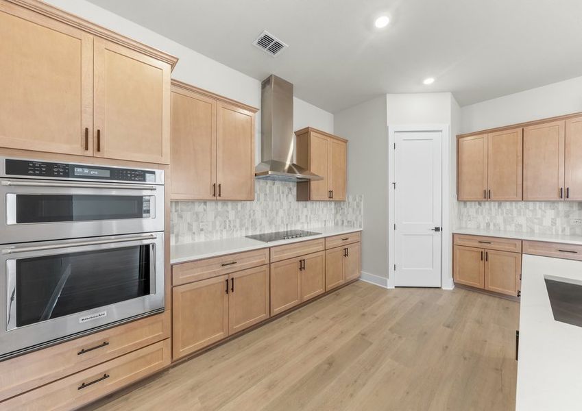 The kitchen has lots of cabinet space and a walk-in pantry that provides ample storage.
