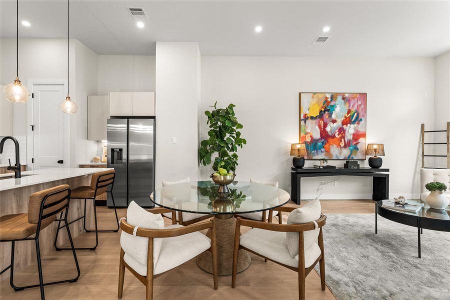 A dedicated dining area sits between the kitchen and living room, keeping everyday meals close to both spaces without interrupting circulation.