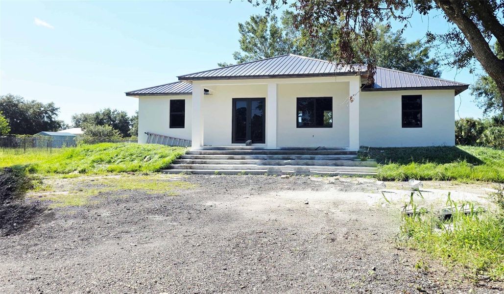 Front exterior of a new home in , Clewiston, FL, highlighting curb appeal (Image 10).