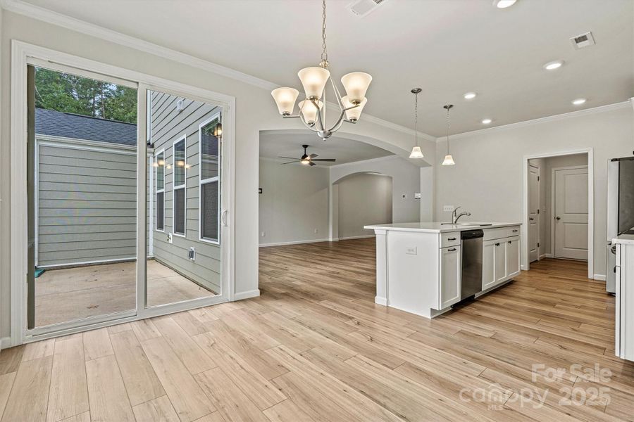 This kitchen features a cozy eat-in nook with sliding doors for easy backyard access This kitchen features a cozy eat-in nook with sliding doors for easy backyard access