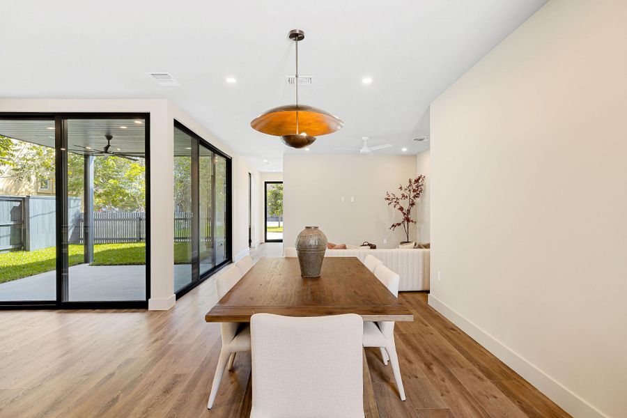 Dining area featuring light wood-type flooring, recessed lighting, and a ceiling fan