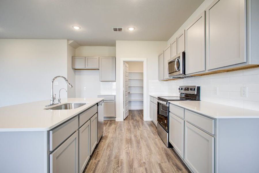 A kitchen with white cabinets. A kitchen with white cabinets.