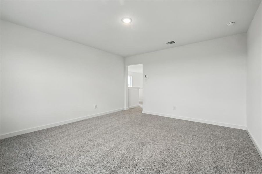 Empty room with carpet flooring and baseboards