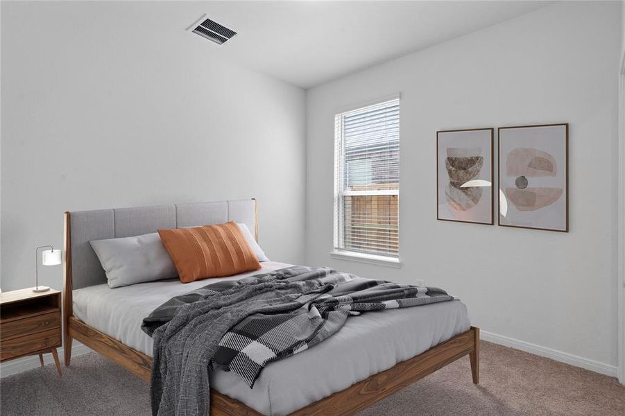 Secondary bedroom features plush carpet, neutral paint, lighting, large window with privacy blinds and ample sized closet space.