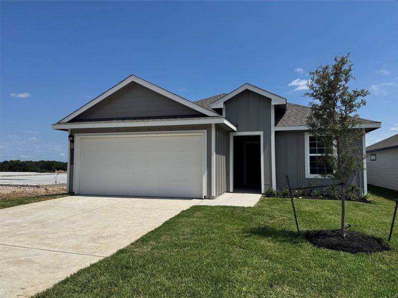 Front exterior of a new home in Wilkins Valley, Brenham, TX, highlighting curb appeal (Image 1).