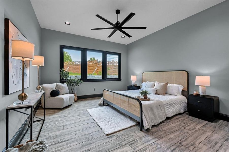 Bedroom with light wood-style flooring, baseboards, recessed lighting, and a ceiling fan Bedroom with light wood-style flooring, baseboards, recessed lighting, and a ceiling fan