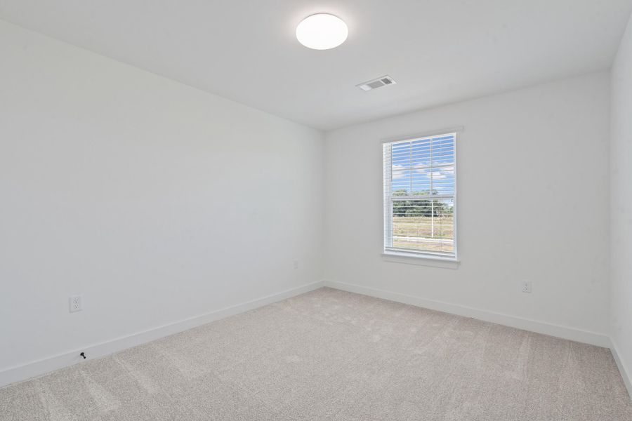 Neutral tone wall finish, light tone carpet flooring, single window with blinds, recessed lighting fixture