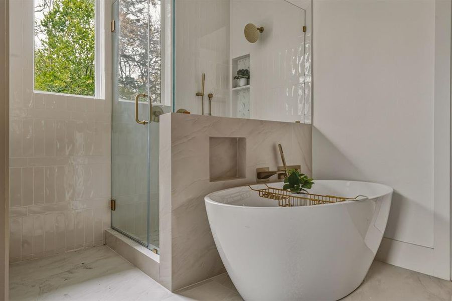 Full bath featuring a stall shower and a freestanding tub