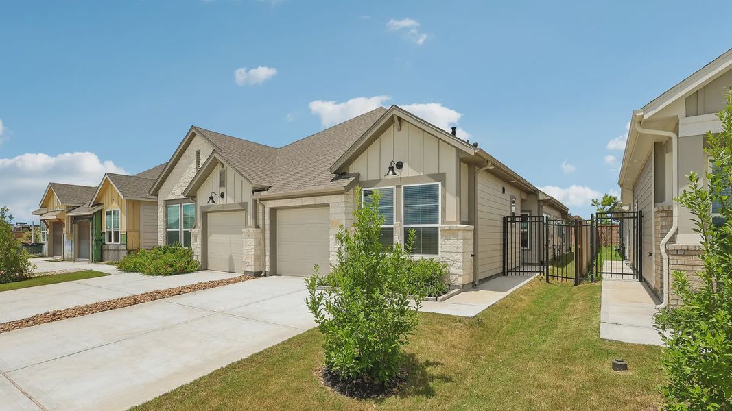 Front exterior of a new home in Meridiana Townhomes, Iowa Colony, TX, highlighting curb appeal (Image 17).