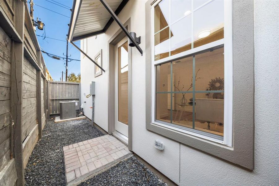 The small backyard space is the perfect size to let the dogs out,  for a grill and a small table and chairs.