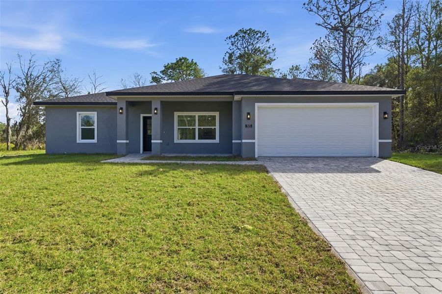 Front exterior of a new home in , Citrus Springs, FL, highlighting curb appeal (Image 17).