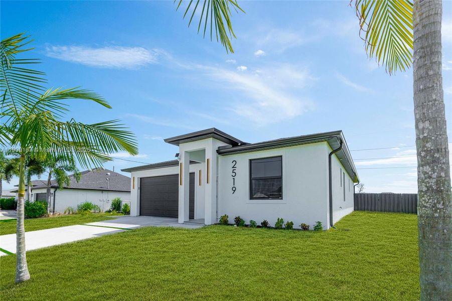 Front exterior of a new home in , Cape Coral, FL, highlighting curb appeal (Image 1). Front exterior of a new home in , Cape Coral, FL, highlighting curb appeal (Image 1).