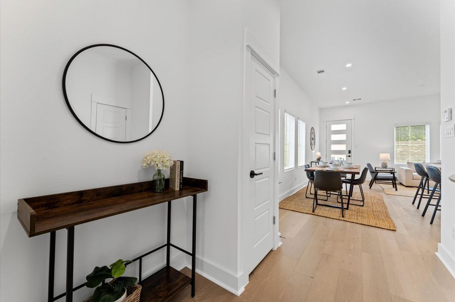 Just inside the garage entry, this thoughtfully designed transition space offers the perfect spot to create a welcoming mood room or a practical drop zone. Whether styled with a console table for keys and essentials or transformed into a cozy nook with seating and décor, it provides both function and charm the moment you step into the home.