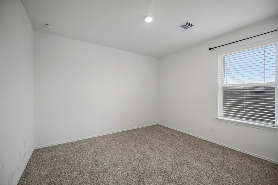 Comfortable upstairs bedroom with a large window Comfortable upstairs bedroom with a large window