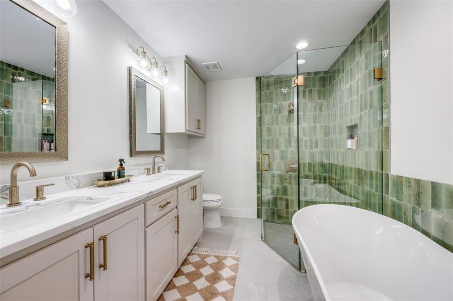 The primary bathroom includes a separate tile shower, double vanity, freestanding tub, and quartz counters.