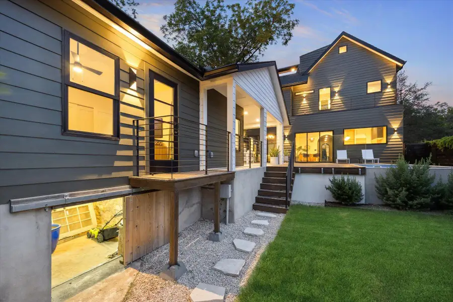 Back of house featuring stairway and a yard Back of house featuring stairway and a yard