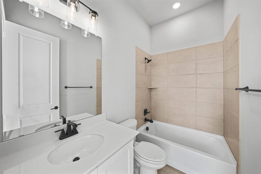 Full bath featuring washtub / shower combination and vanity Full bath featuring washtub / shower combination and vanity